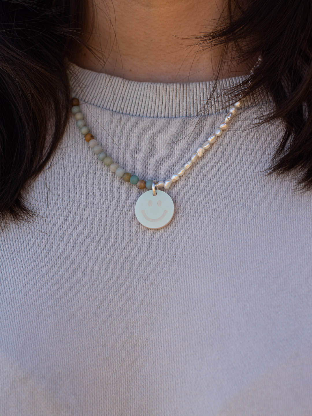 Necklace with peals, stones and smiley-pendant